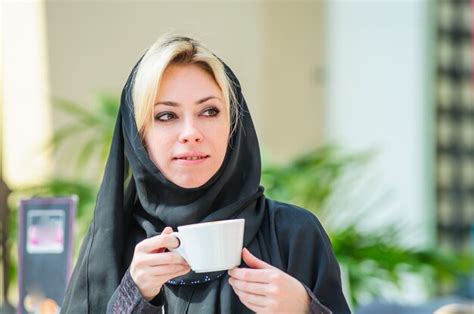 premium photo beautiful arabic woman in a restaurant drinking a coffee arabic fashion style
