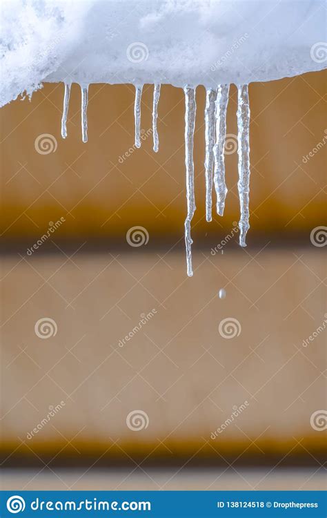 Translucent Icicles On A Roof Seen On A Sunny Day Stock Photo Image
