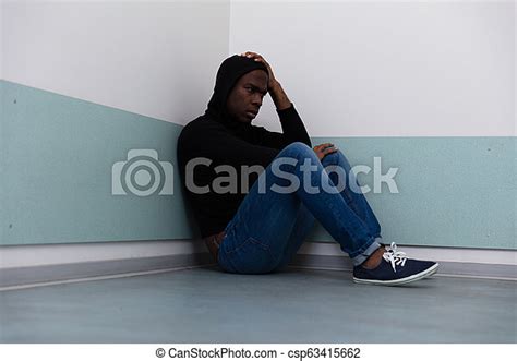 Depressed Man Sitting On Floor Depressed African Man Sitting Alone On