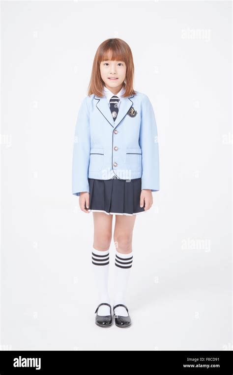Elementary School Girl In School Uniforms With Short Hair Standing With