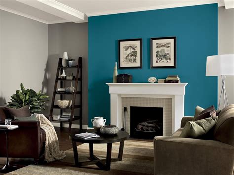 A Living Room With Blue Walls And White Trimmings On The Fireplace Mantel
