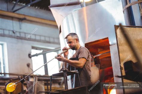 Glassblower Shaping A Glass On The Blowpipe At Glassblowing Factory — Caucasian Ethnicity
