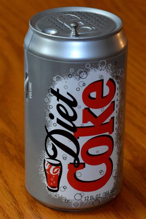 A Can Of Diet Coke Sitting On Top Of A Wooden Table