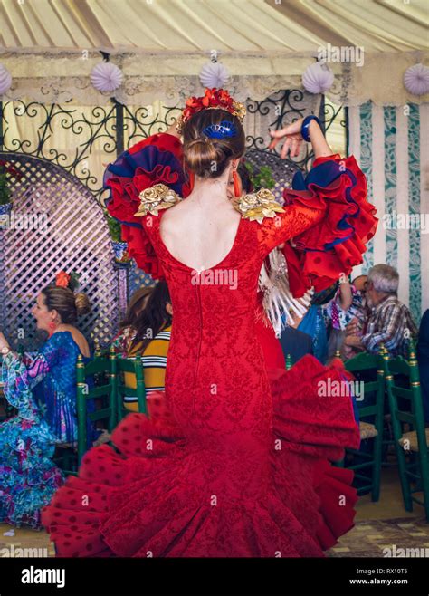Young And Beautiful Women Wearing Flamenco Dresses And Dancing