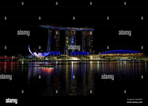 The Lights Of Marina Bay Sands Hotel Reflecting On The Water Of Marina