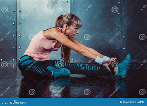 Fit Woman Doing Stretching Exercises Her Muscles Back And Legs Before A