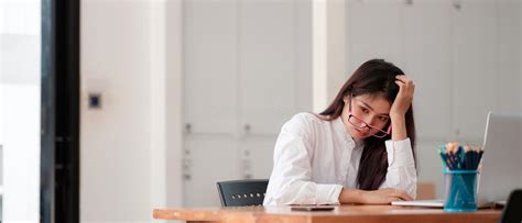 Bored Asian Female Worker Lie At Office Desk Think About Problem