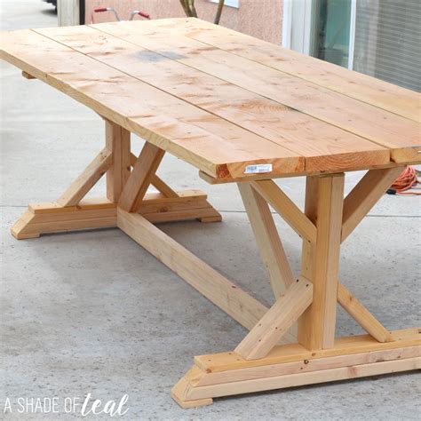 The sleek choco edged top on the white painted base are the accent features of this farmhouse coffee table. Building a Outdoor Rustic Farmhouse Table | A Shade Of Teal