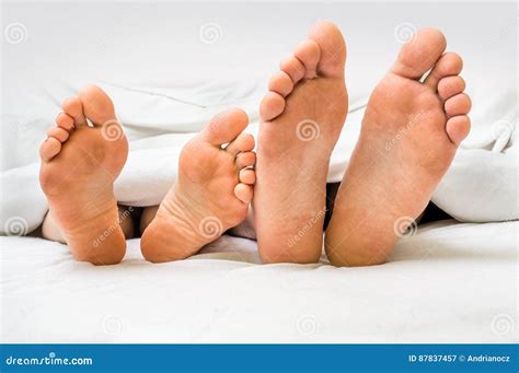 Feet Of A Couple In Bed Under The Blanket Stock Image Image Of Home Pair 87837457
