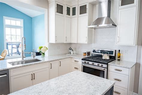 It keeps them from needing to replace the cabinets completely. Transitional with a pop of color kitchen remodel | EmpireGMQ - Buffalo, NY