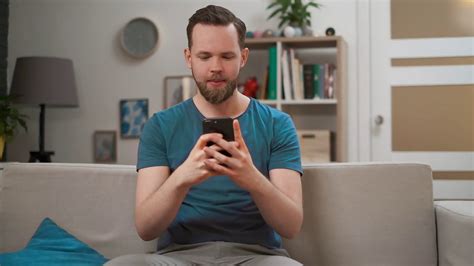 Young Man Using Smartphone On Couch At Home Stock Footage Sbv 335199567