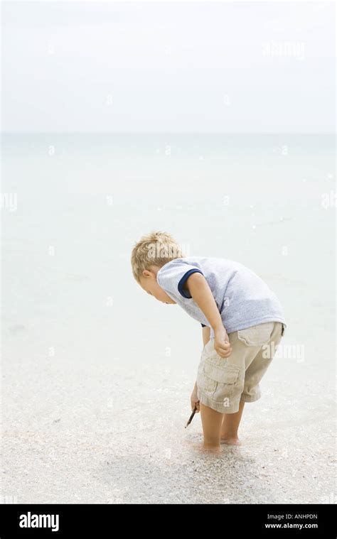 Little Boy Bending Down In Hi Res Stock Photography And Images Alamy