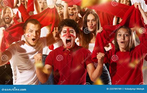 Excited Football Soccer Fans Cheering Their Team With A Red Scarfs At