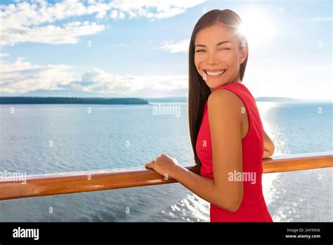 Happy Cruise Ship Passenger Outside On Suite Balcony Enjoying Luxury View Of Ocean In Travel