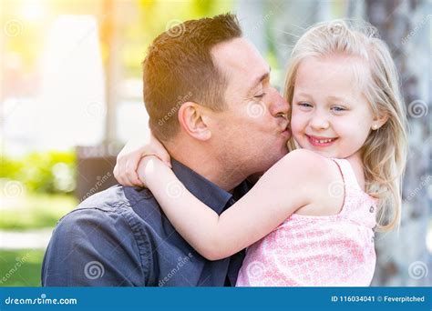 Young Caucasian Father Gives Daughter A Kiss On The Cheek Stock Image