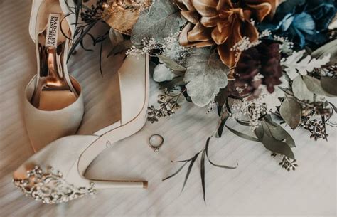 Wedding Shoes And Bouquet On The Floor With Pine Cones In The Backgroung