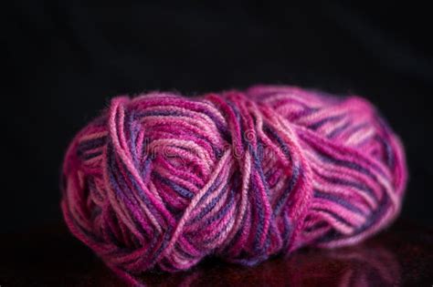 A Multi Colour Ball Of Wool Against A Black Background Stock Photo