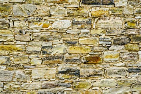 Closeup Background With A Fragment Of An Old Limestone Brick Wall Stock