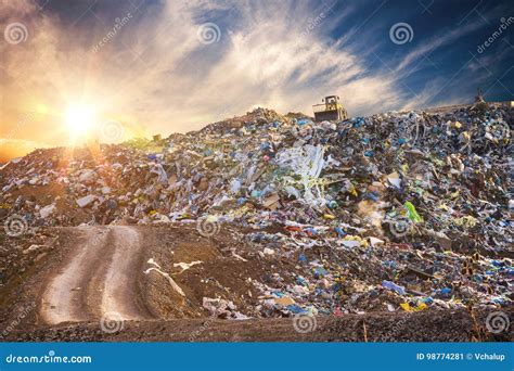 Pollution Concept Garbage Pile In Trash Dump Or Landfill At Sunset