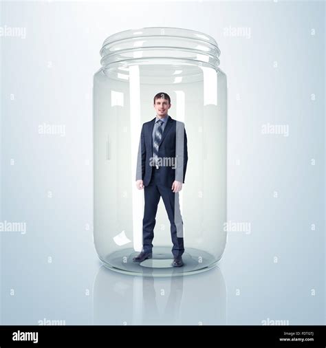 Businessman Trapped Inside A Transparent Glass Jar Stock Photo Alamy