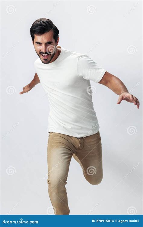 Fashion Man Jumping And Running In A White T Shirt And Jeans Smile