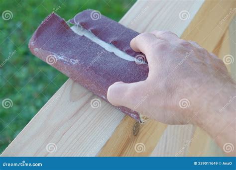 Sanding Wood A Male Carpenter Is Sanding The Wooden Beams Of A Made