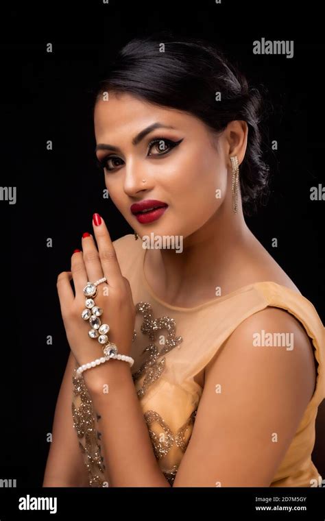 Beautiful Woman With Smile Showing Diamond Jewelry On Her Hand In Light