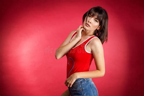 Slender Brunette Posing On A Red Background In Shorts Fitness Girl Stock Image Image Of
