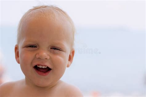 Funny Laughing Toddler On The Beach Looking At Camera Copy Space Stock