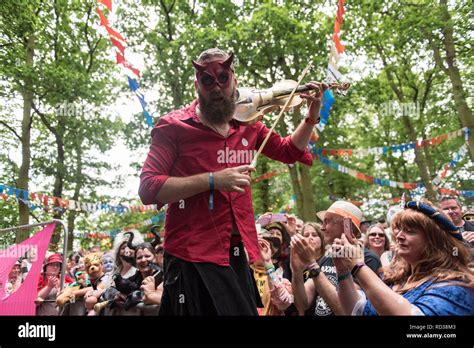 Man Dressed As The Devil Playing The Violin At A Music Festival Stock