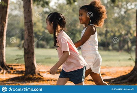 Two Little Mixed Race African Black And Caucasian White Girls Playing