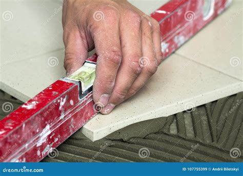 Ceramic Tiles And Tools For Tiler Worker Hand Installing Floor Stock