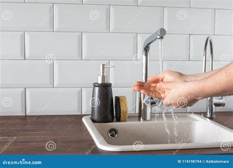 Hand Washing Underwater From A Faucet In The Kitchen Leanliness Water