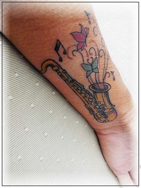 Saxophone Tattoo On Inner Wrist Featuring Alto Saxophone Butterflies