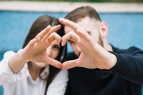 Couple Forming Heart With Hands Free Photo