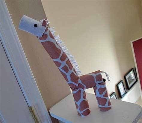 A Stuffed Giraffe Sitting On Top Of A White Table Next To A Mirror