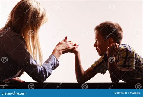 Mother And Son Arm Wrestle Sit At Table Stock Image Image Of Strong