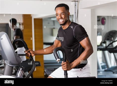 Black African American Young Man Doing Cardio Workout At The Gym Stock