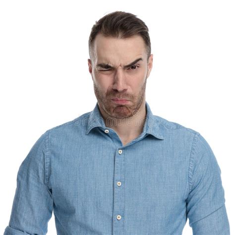 Disgusted Casual Man Frowning And Looking Over His Shoulder Stock Photo