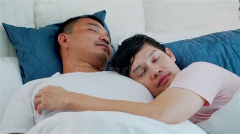 Lgbtq Couple Two Men Snuggle Up To Each Other In Bed Warmly Loving