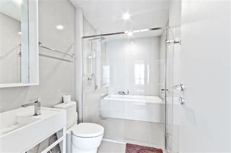 To maintain the clean lines, the mirror and slender shelves were recessed into an new 2x6 wall for additional storage. 15 Beautiful Small Bathroom Designs