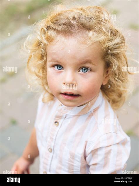 Handsome Boy With Blue Eyes And Curly Blond Hair Stock Photo Alamy