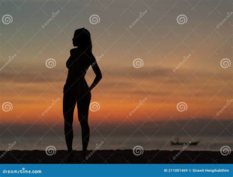 Silhouette Portrait Of Woman Wearing Bikini On The Beach Golden Sunset Moment Holiday And