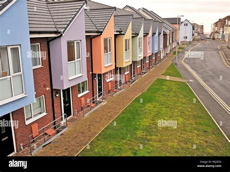 Row Of Affordable New Build Homes Finished Off In Different Pastle