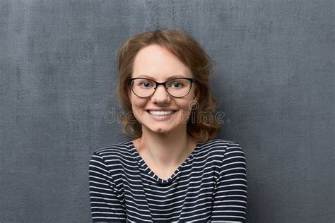 Portrait Of Young Woman With Eyeglasses Smiling Broadly Stock Photo