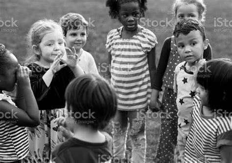 Group Of Children Playing Together In A Park Stock Photo Download