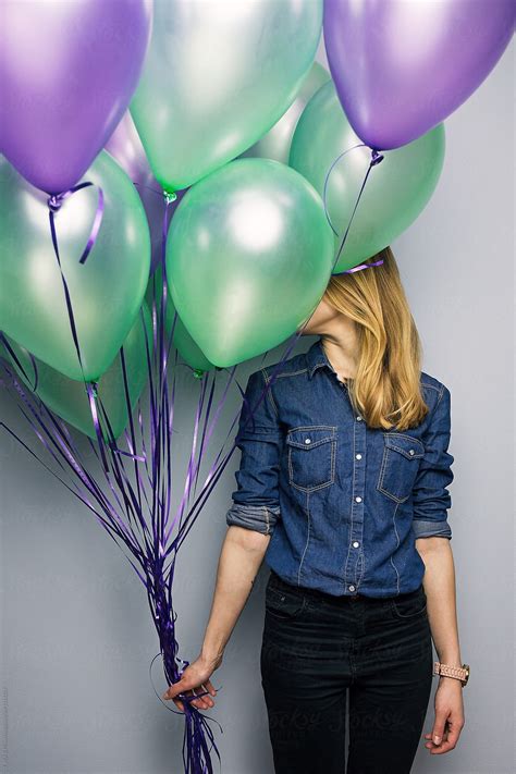 Woman Closed Face With Balloons Bunch Del Colaborador De Stocksy