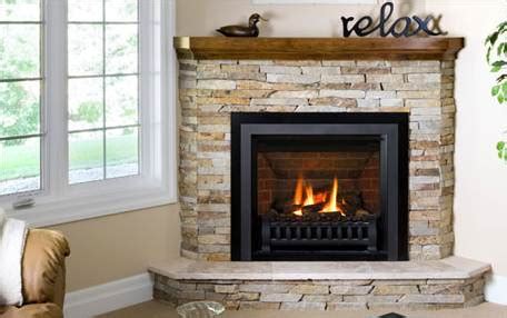 Overview of a stone veneer fireplace surround. The Corner Gas Fireplace . . . A Great Way To Maximize Your Space!
