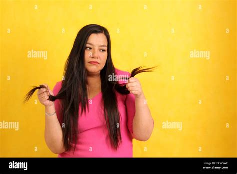 Adult 40 Year Old Latina Woman With Long Straight Hair Suffers From Her Damaged Hair With Split