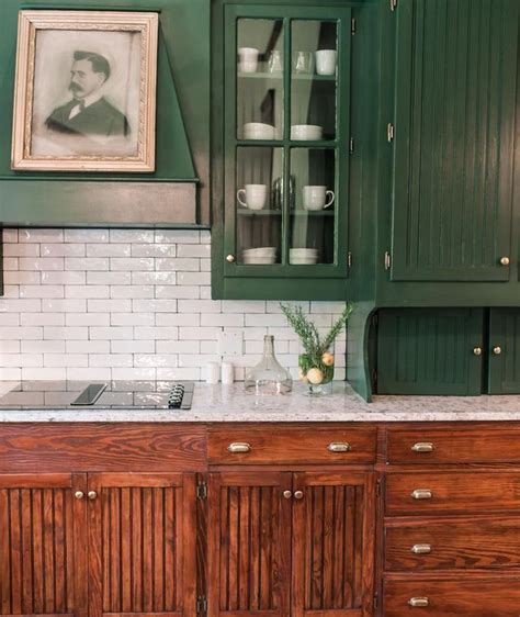 A Kitchen With Green Cabinets And White Marble Counter Tops An Old